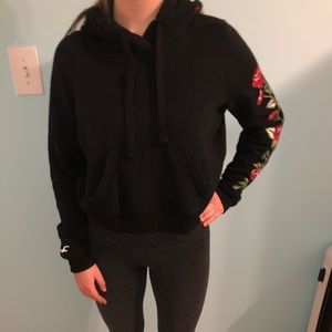 Black cropped sweatshirt with rose detailing